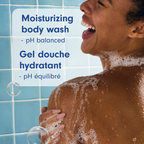 A person smiling in a blue-tiled shower, washing their shoulder with a rich lather. Text in English and French: Moisturizing body wash, pH balanced; Gel douche hydratant, pH équilibré.