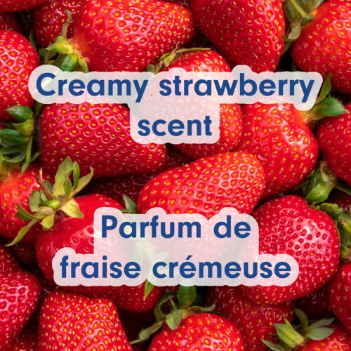 A bright pile of fresh red strawberries representing the scent profile. Text in English and French: Creamy strawberry scent, Parfum de fraise crémeux.