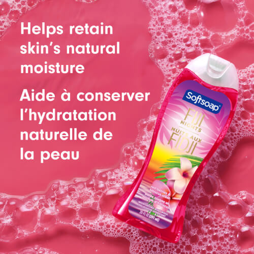 The Fiji Nights bottle is shown tilted on a vibrant pink background covered in soapy suds and bubbles. Text reads "Helps retain skin’s natural moisture" and "Aide à conserver l’hydratation naturelle de la peau."
