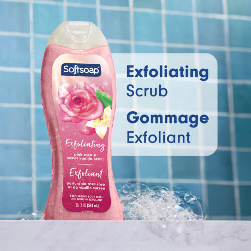 A 20-ounce bottle of Softsoap Exfoliating Body Wash in Pink Rose and Sweet Vanilla scent, displayed against a blue tiled background. Large text to the right reads "Exfoliating Scrub" in English and "Gommage Exfoliant" in French.