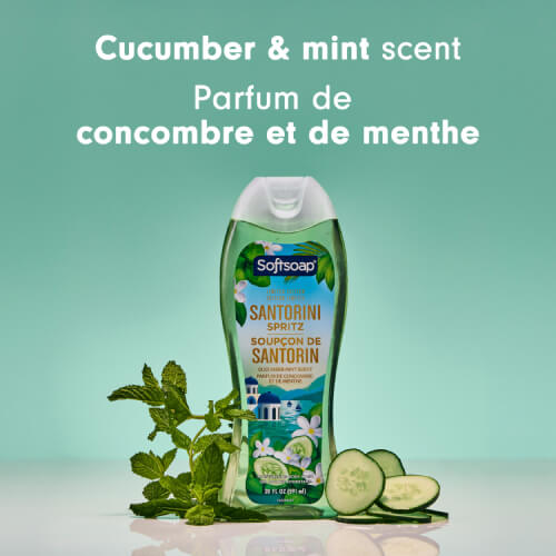 A bottle of Softsoap Santorini Spritz moisturizing body wash (Limited Edition), centered between fresh mint leaves and cucumber slices. The text above reads: "Cucumber & mint scent."