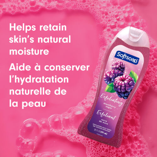 Softsoap Blackberry Sugar bottle laying in vibrant pink soapy water with bubbles. Text overlay reads "Helps retain skin’s natural moisture" and "Aide à conserver l’hydratation naturelle de la peau."