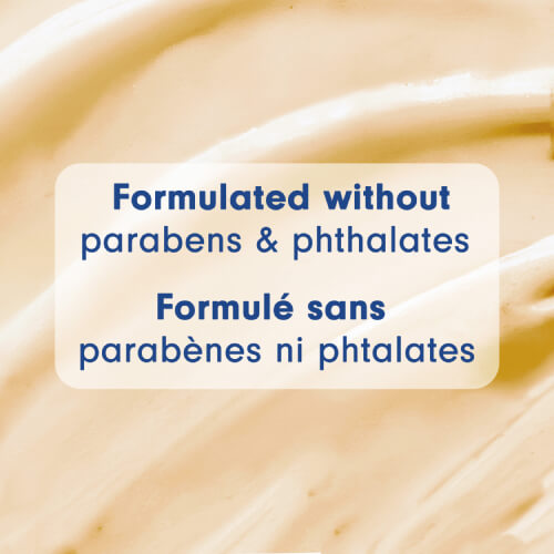 A macro view of the smooth, golden-tan creamy texture of the body wash. A text box in the center states "Formulated without parabens & phthalates" and "Formulé sans parabènes ni phtalates."